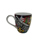 A ceramic coffee mug featuring a colorful Mardi Gras themed 'Bourbon Street' design with a masquerade mask, fleur-de-lis, and New Orleans architecture, shown on a plain white background.