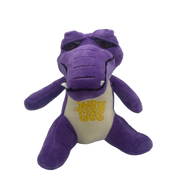 A purple plush alligator toy with a cream-colored belly embroidered with 'Mardi Gras' in yellow, shown against a plain white background.