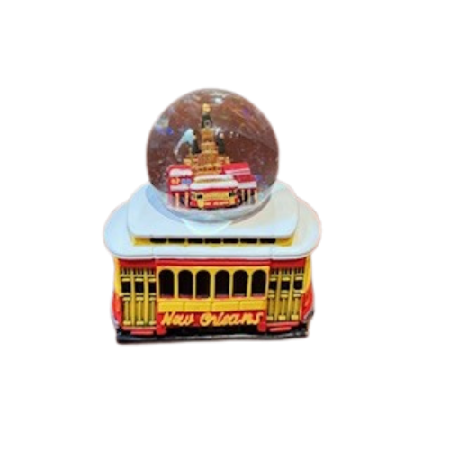 Decorative item with a New Orleans theme featuring a streetcar and a ball on top.