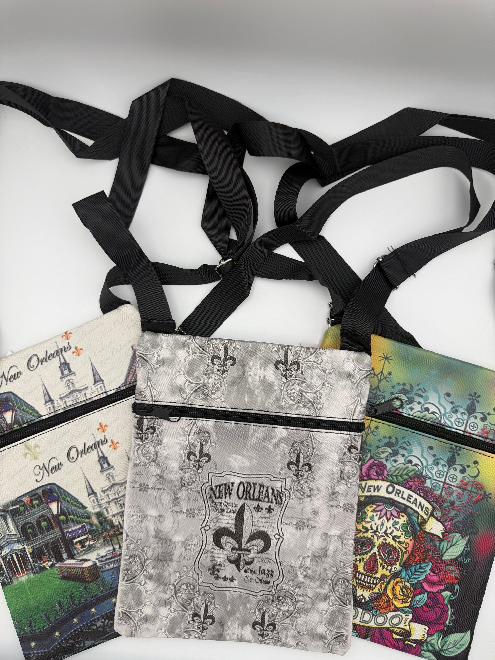 Collection of New Orleans-themed pouches with straps on a white background