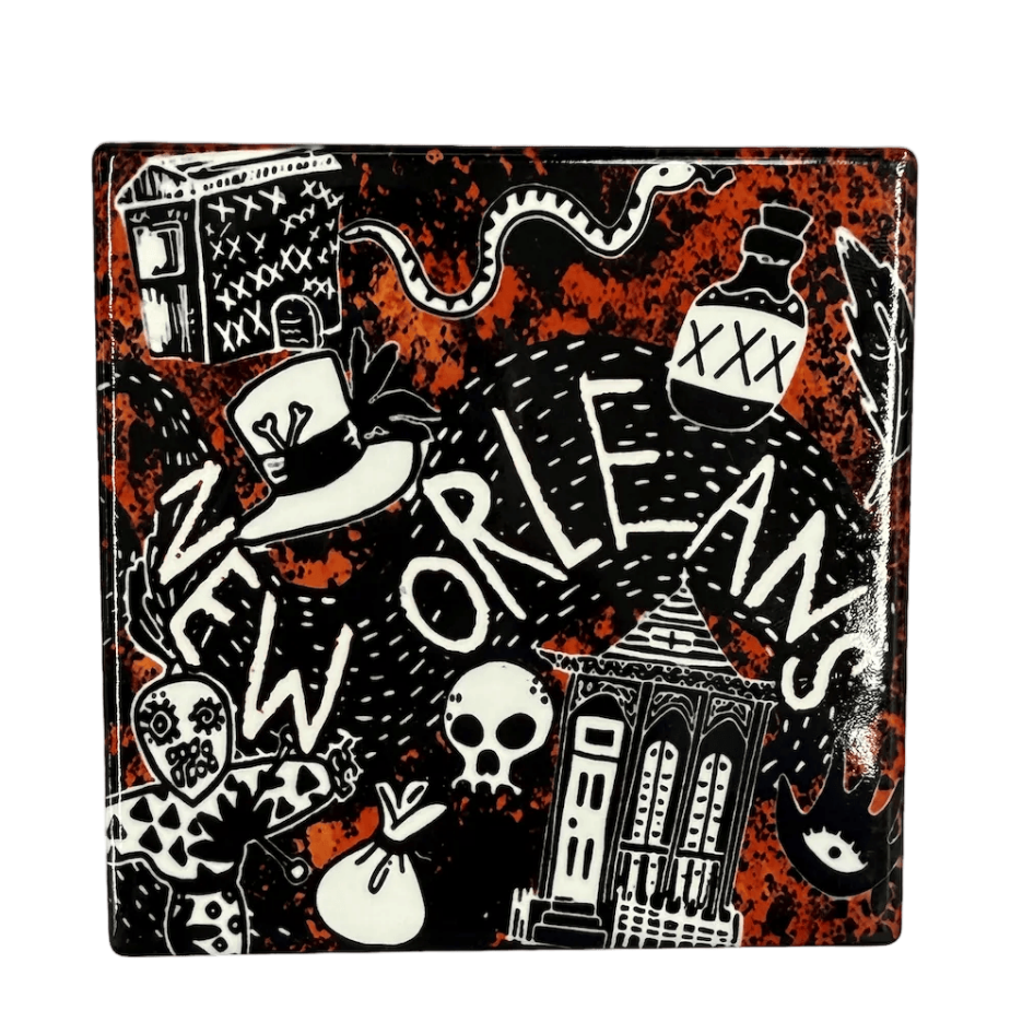 Decorative ceramic tile with New Orleans-themed design on a black background