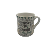 White mug with black text and green accents on a white background
