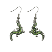Geco-shaped earrings with green gemstones on a white background
